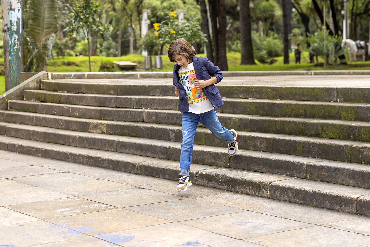 A man runs up a flight of park steps