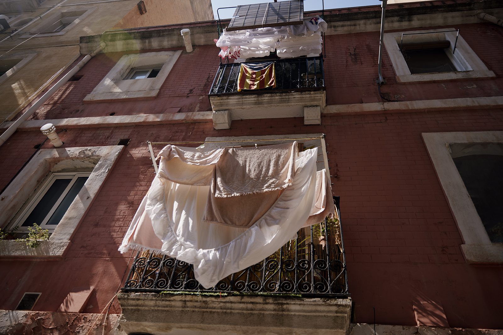 Laundry hangs from an ornate Barcelona balcony