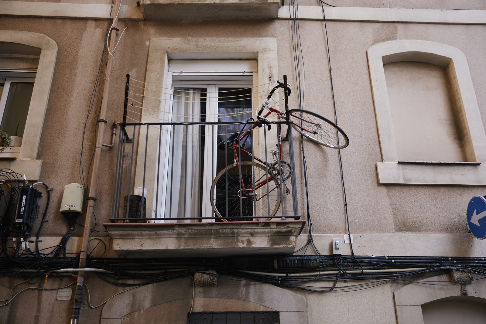 Wires and a window on a weathered Barcelona wall
