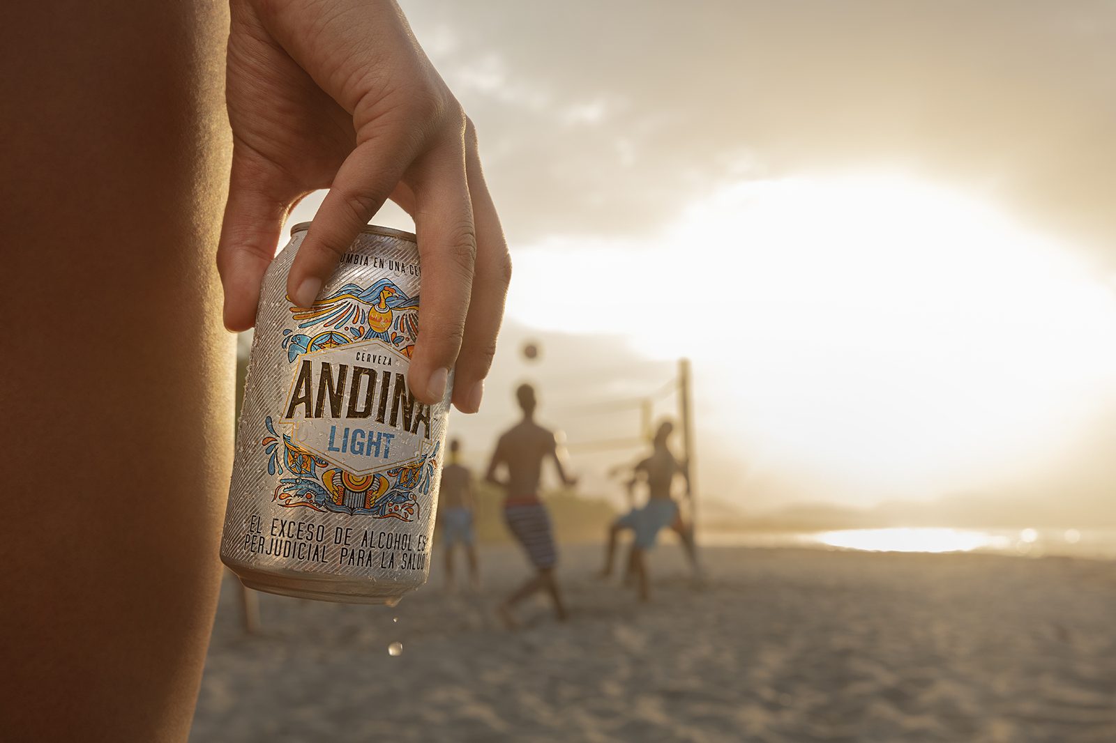 Friends watch the sunset on the beach with drinks