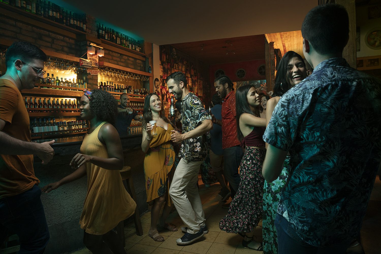 A group dances together in a bar