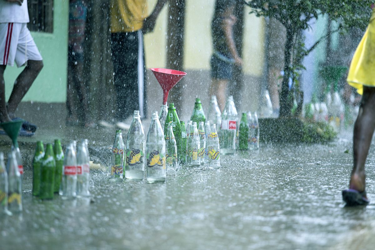 Rows of green bottles standing in the rain