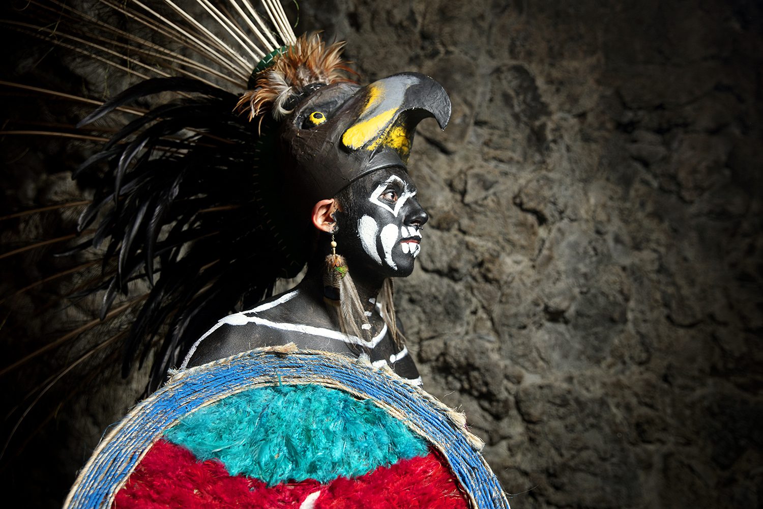 An Aztec dancer in feathered headdress and body paint