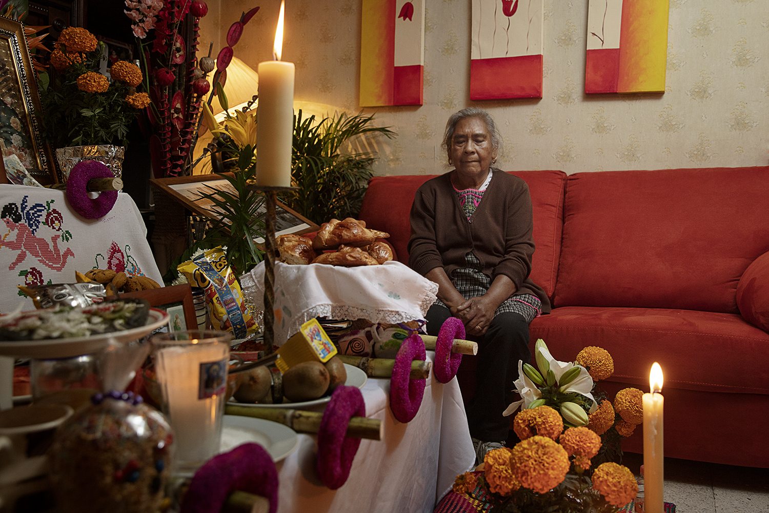 A marigold ofrenda laid out with bread and offerings