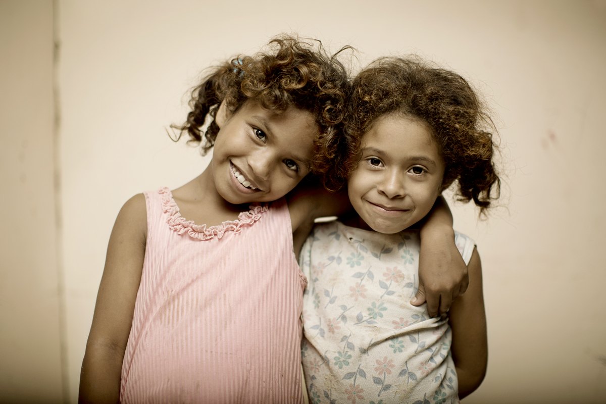 Portrait of two young sisters from a community near the operations