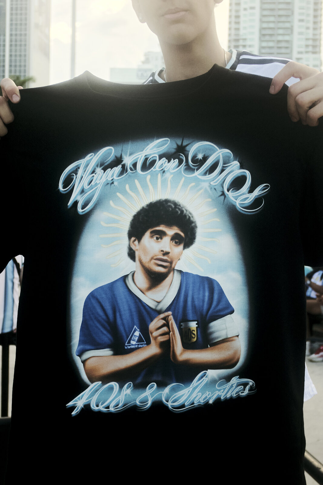 A Maradona tribute shirt held up over an Argentina jersey