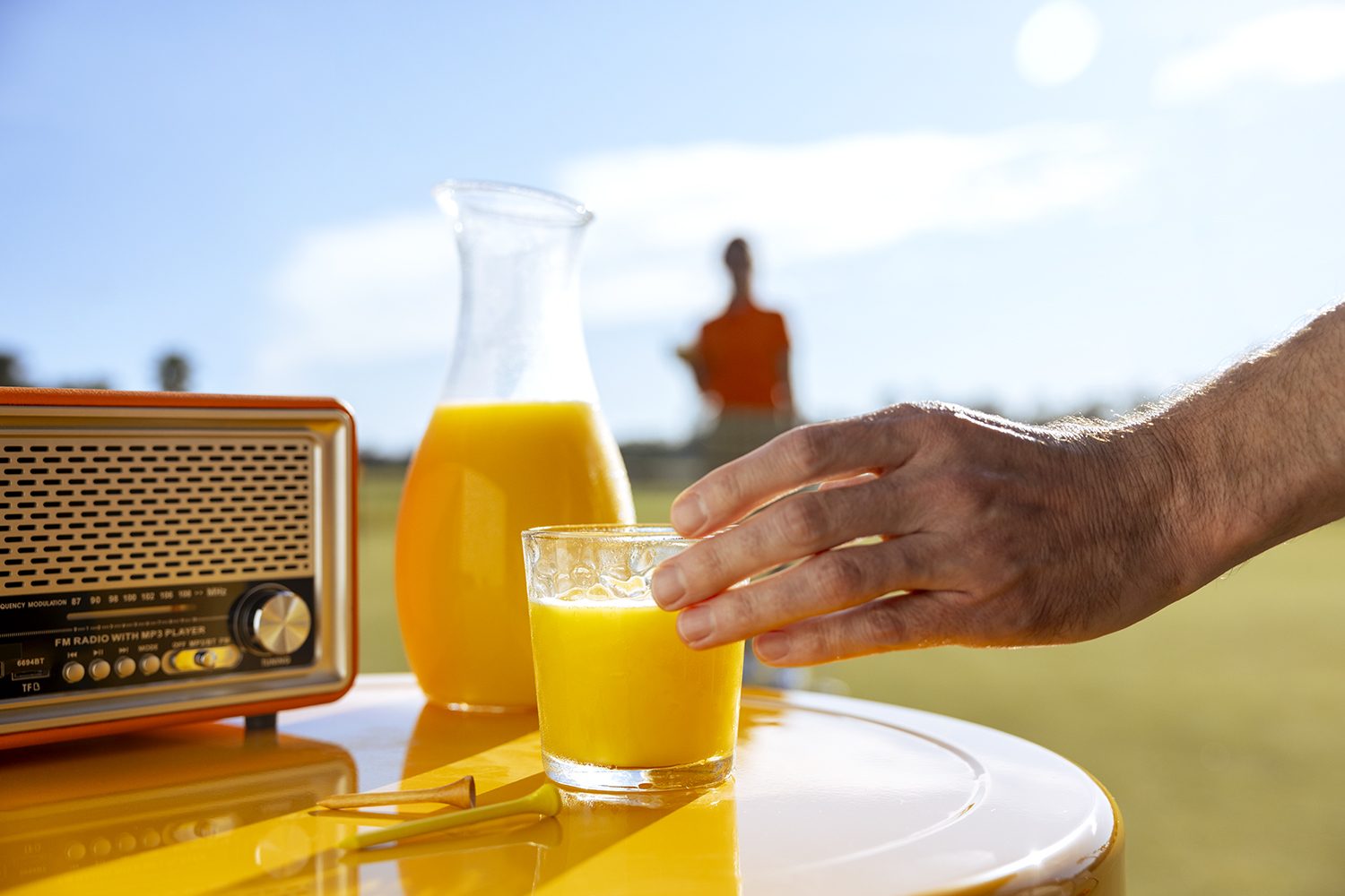 A retro radio and a glass of orange juice as a still life