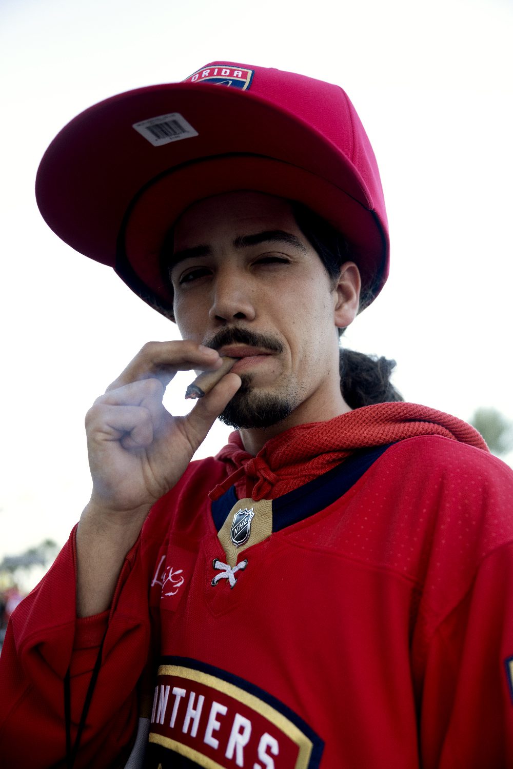 A young fan in a red cap and jersey