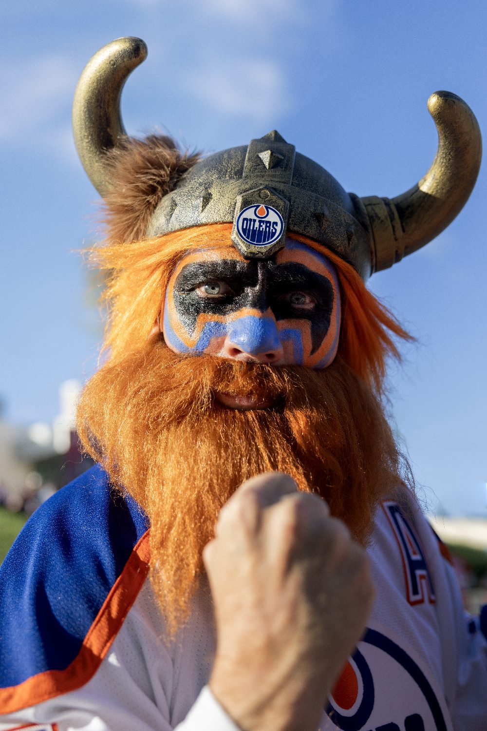 A fan in a horned Viking helmet and orange beard