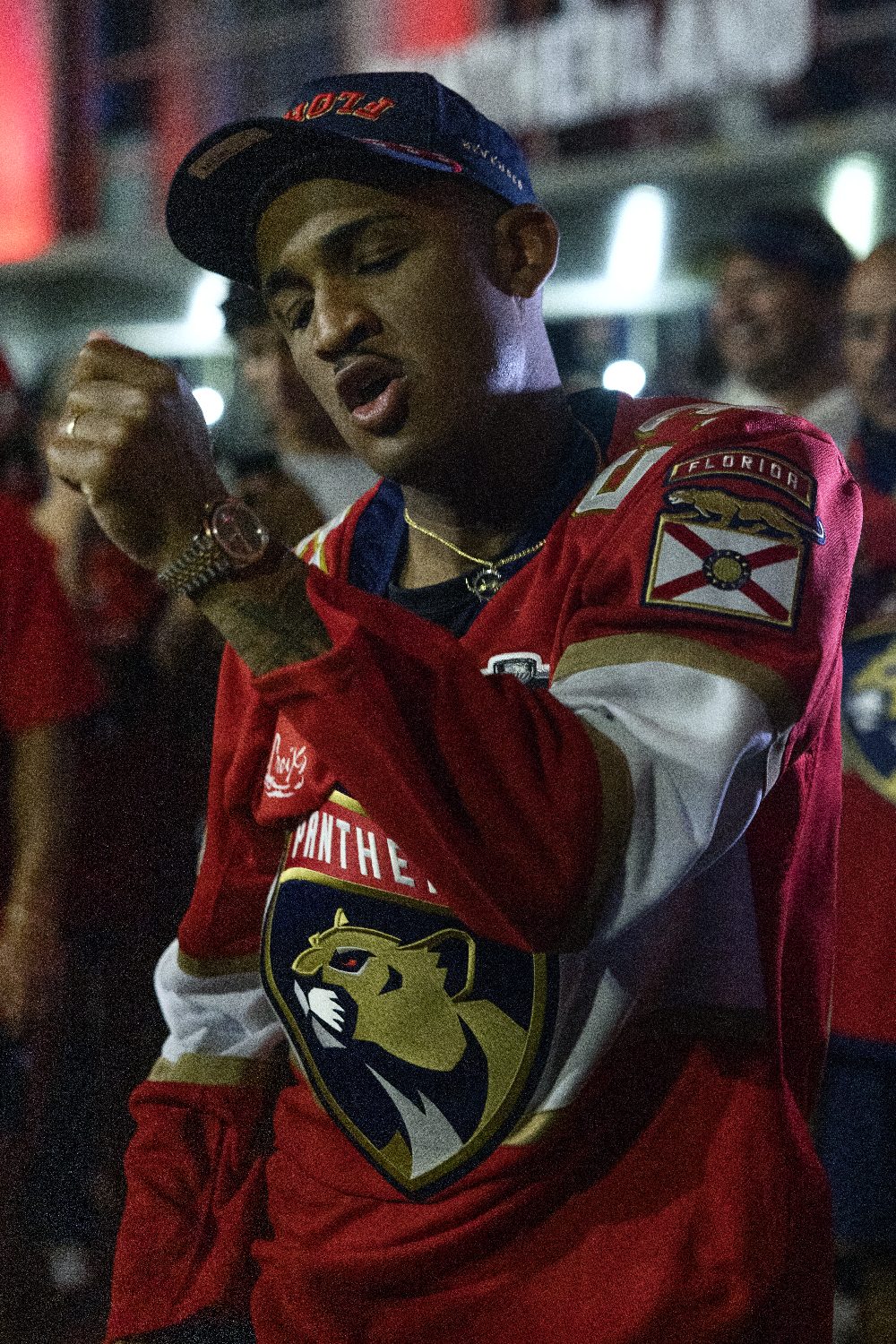 A fan cheers in a Panthers jersey outside the arena