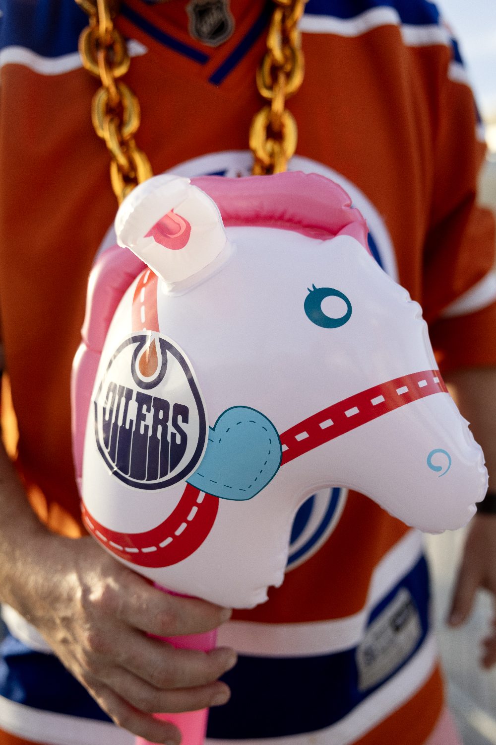 A fan holds up a toy in team colours