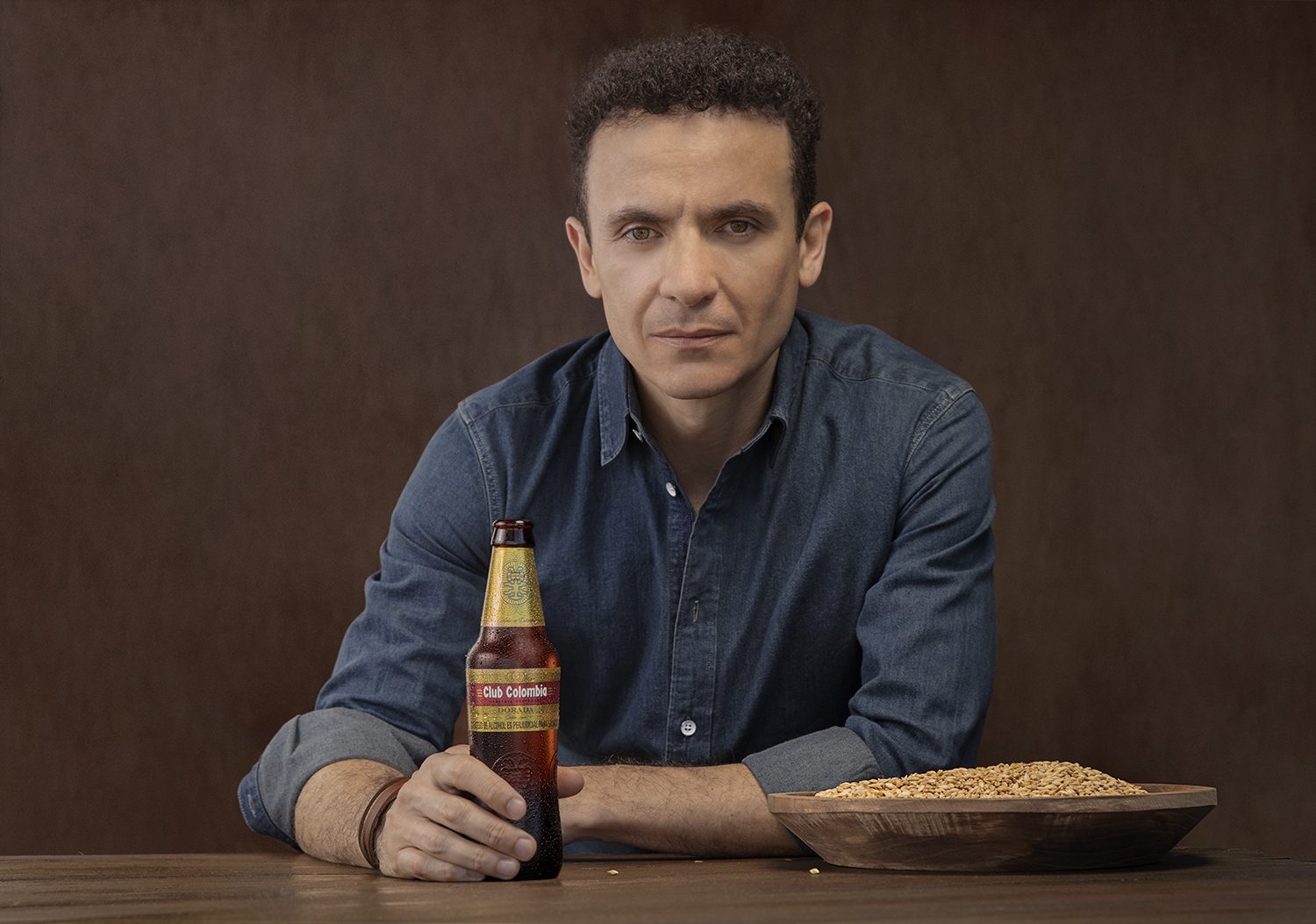 A studio portrait of the singer with a beer