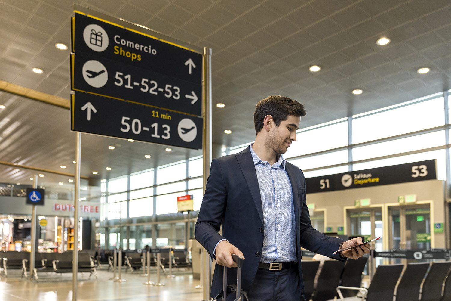 A traveller checks a departures board in the terminal