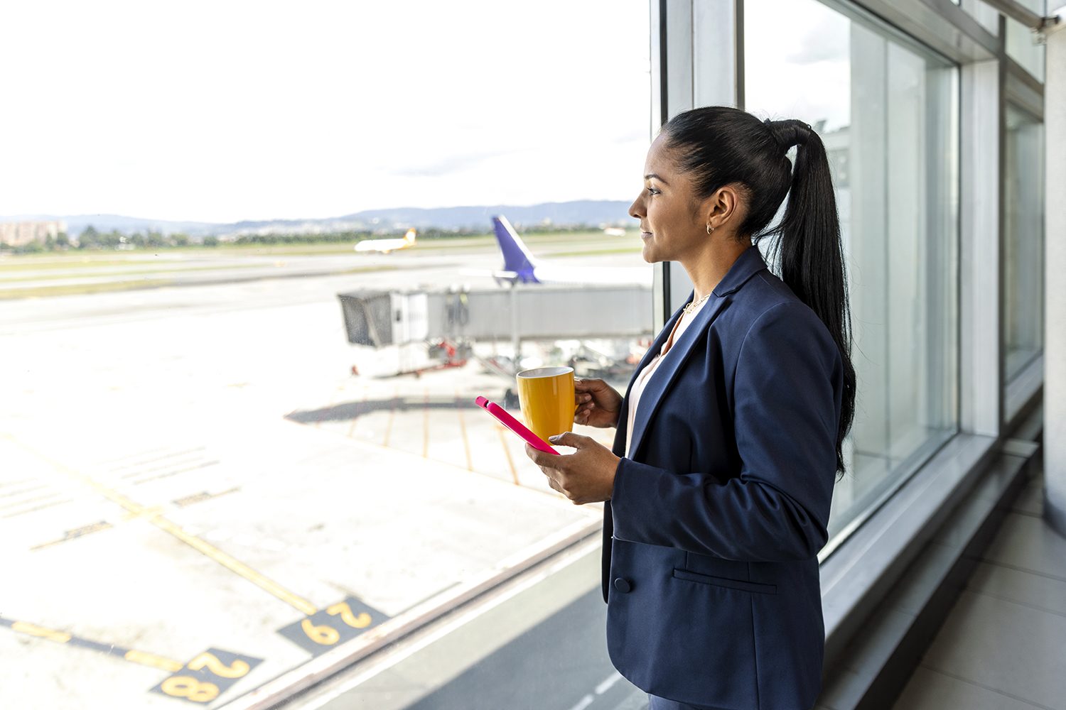 A man reviews his phone near the departure gate