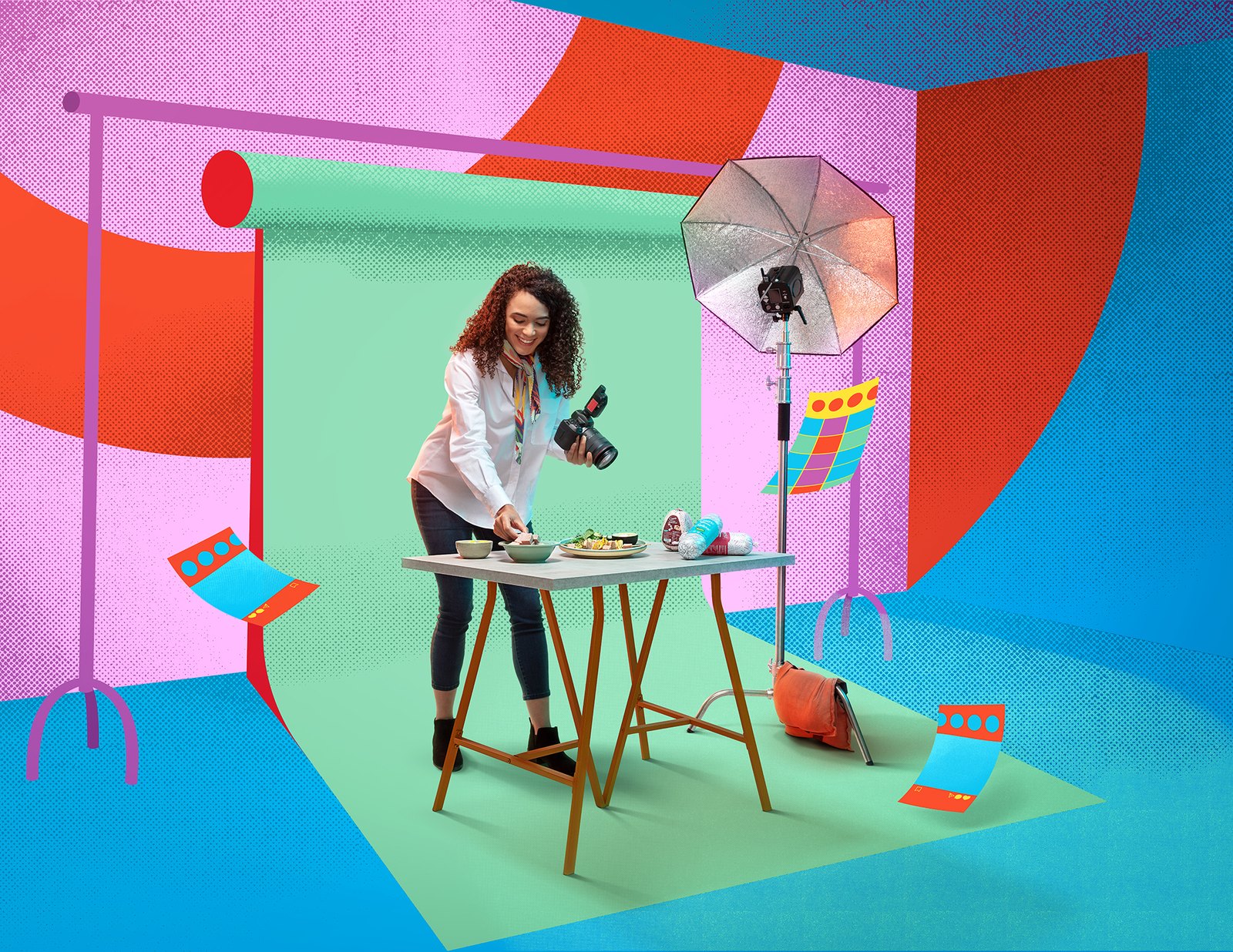 A woman at a small table in a pastel set of intersecting coloured planes