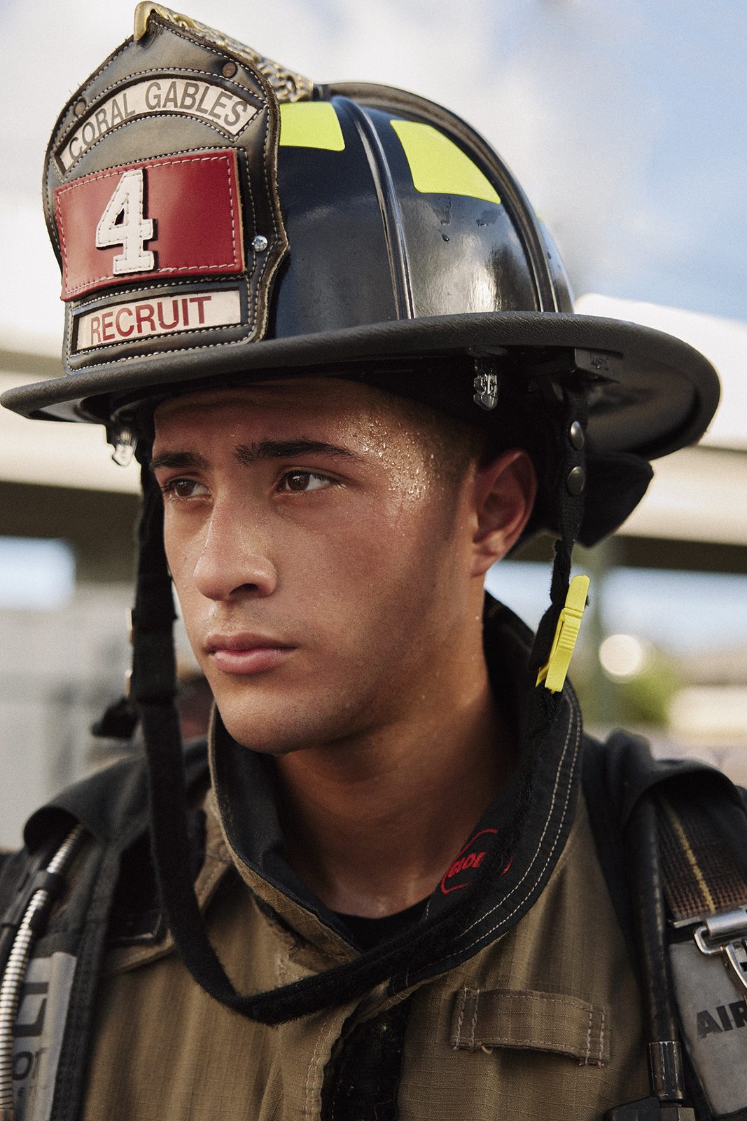 Firefighter portrait against the station wall