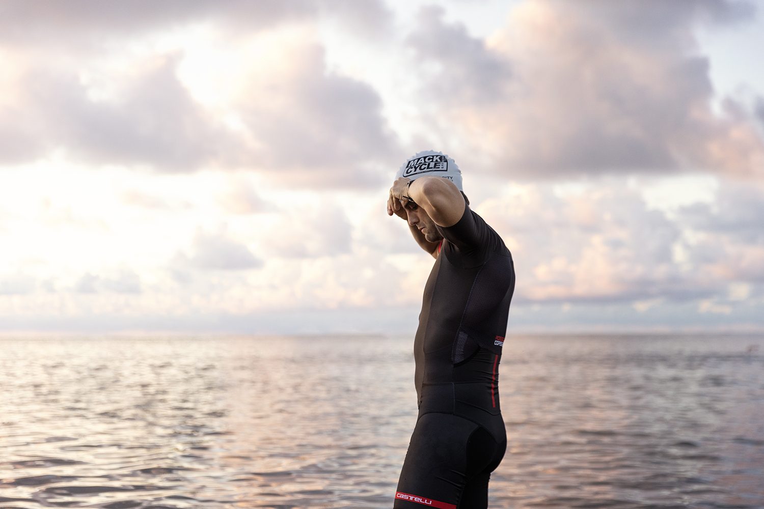 A swimmer silhouetted against the rising sun