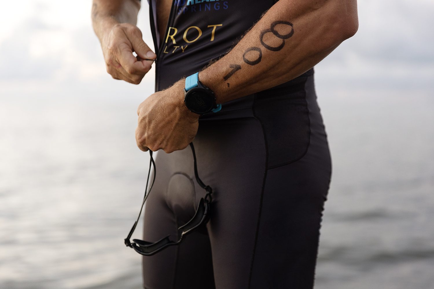 Detail of a triathlete preparing race gear at sunrise