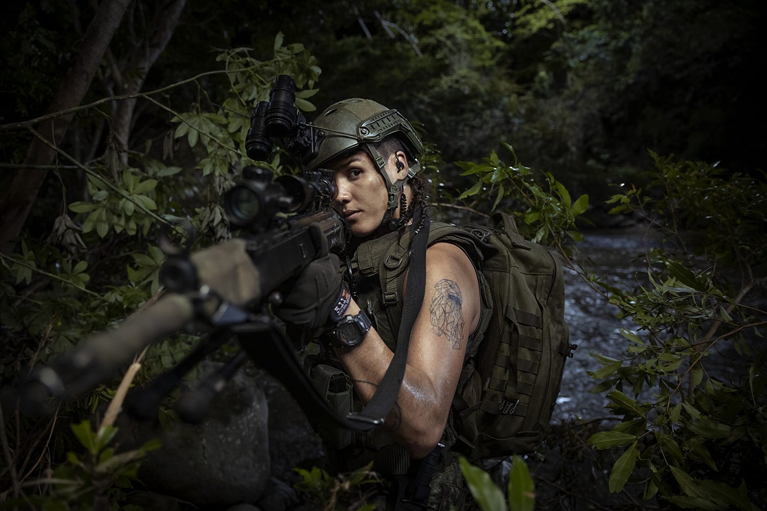 A soldier moves through dense jungle, cinematic still