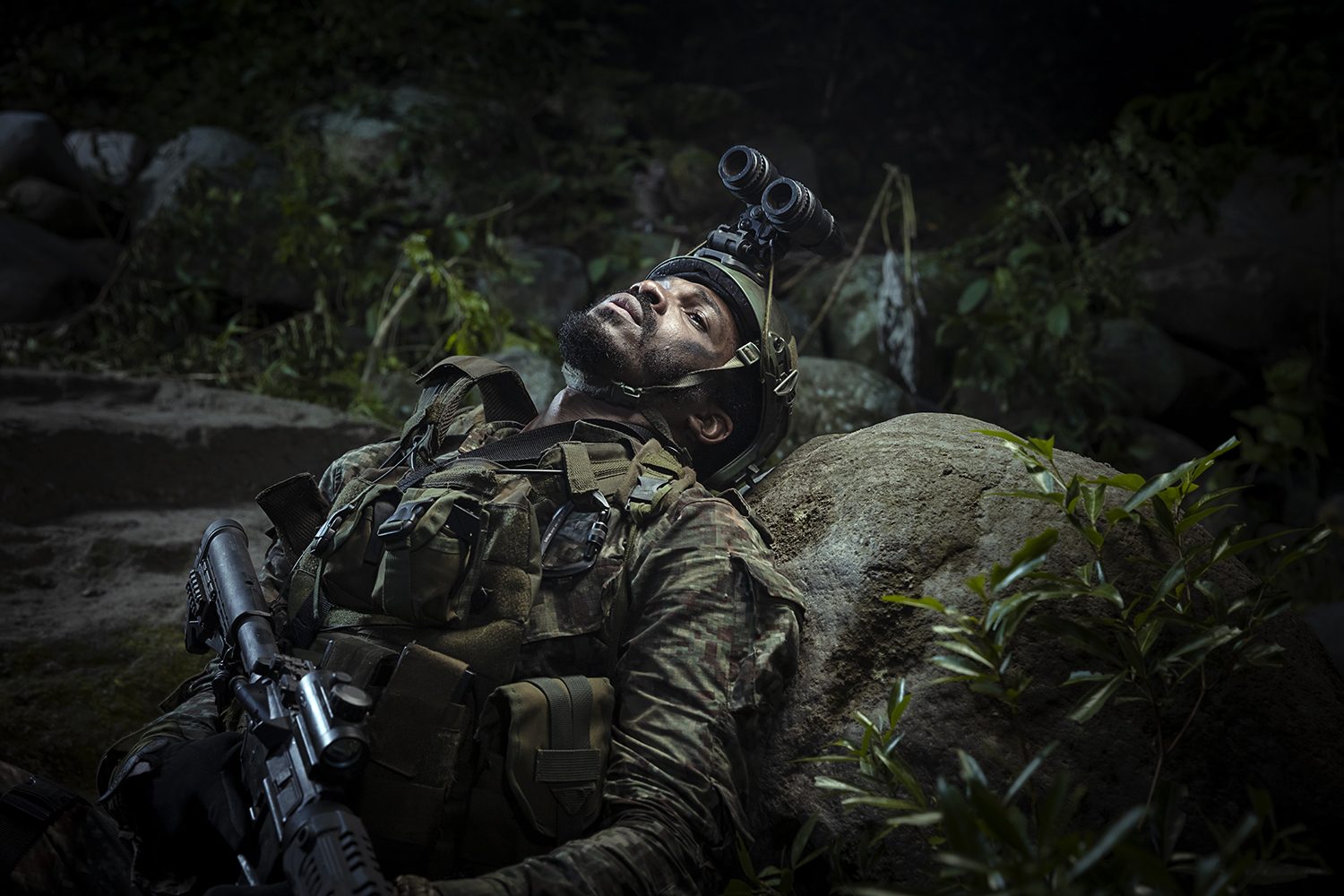 A fallen figure on the jungle floor in low light