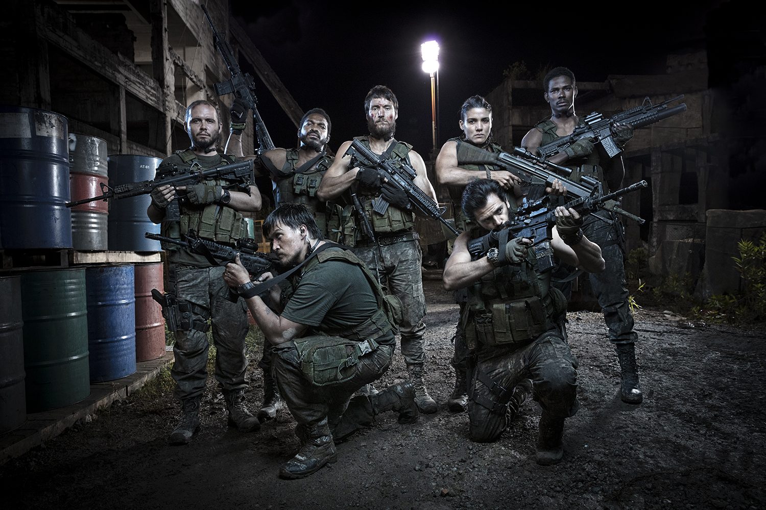 The cast posed together in a gritty group portrait