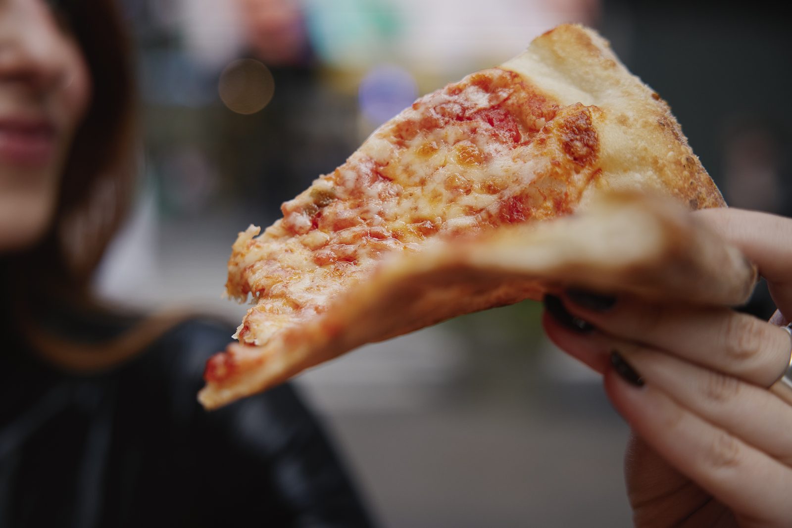Eating a folded slice of New York pizza
