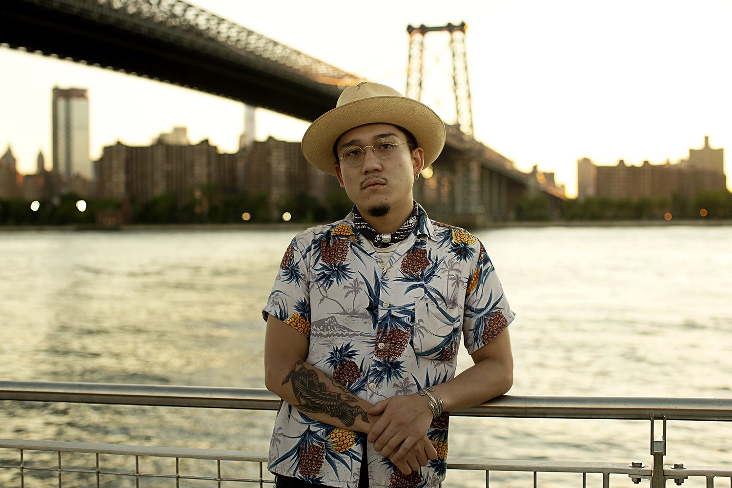 On the waterfront railing with the Williamsburg Bridge crossing behind
