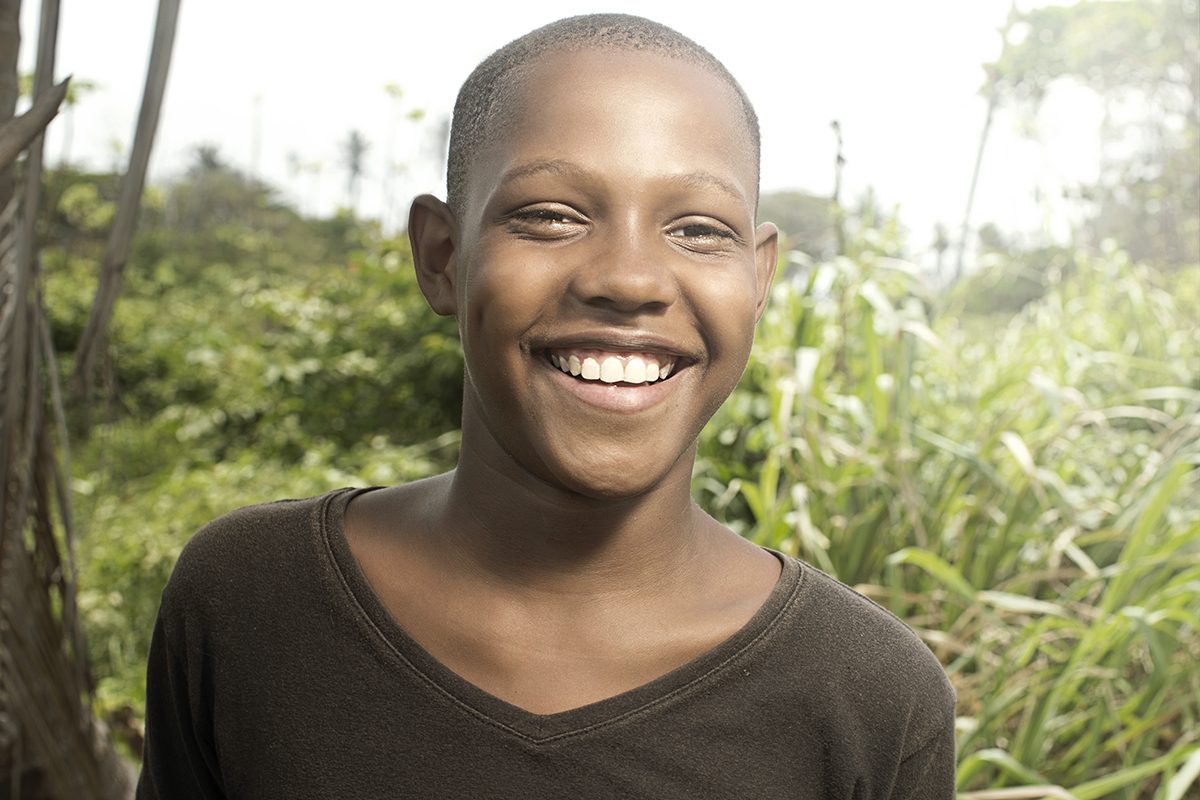 A young boy smiles on a San Andrés street