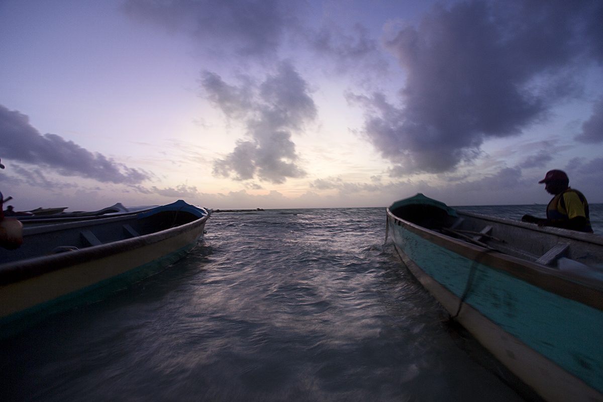 Painted fishing boats at dusk on the shore
