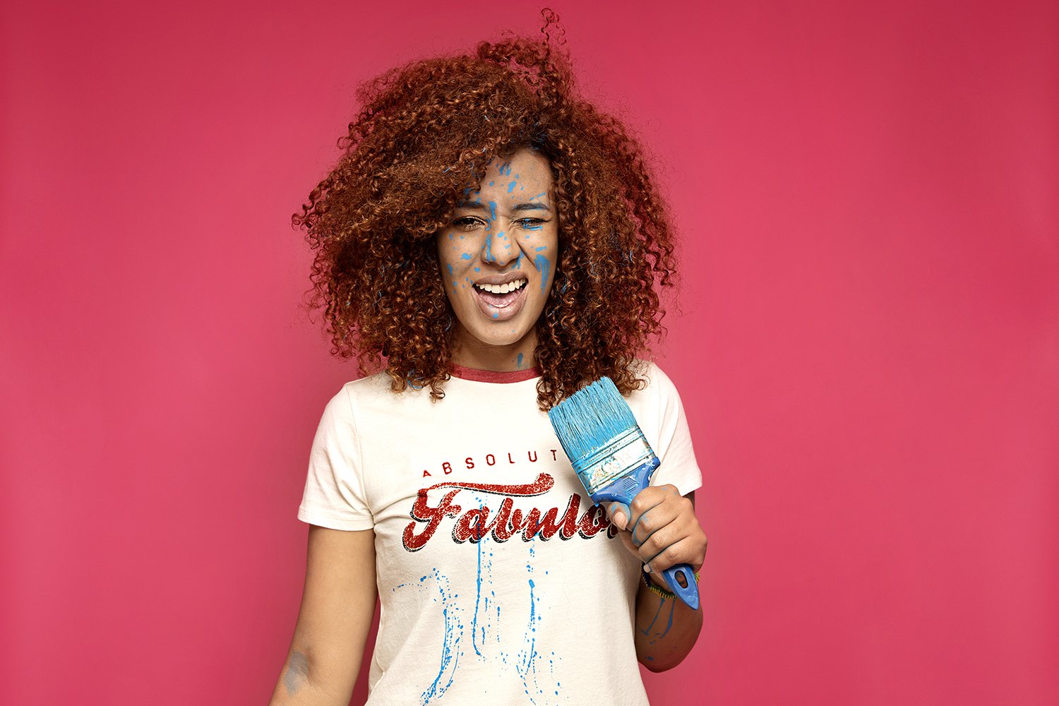 Laughing with a hand in her hair, printed tee, pink seamless