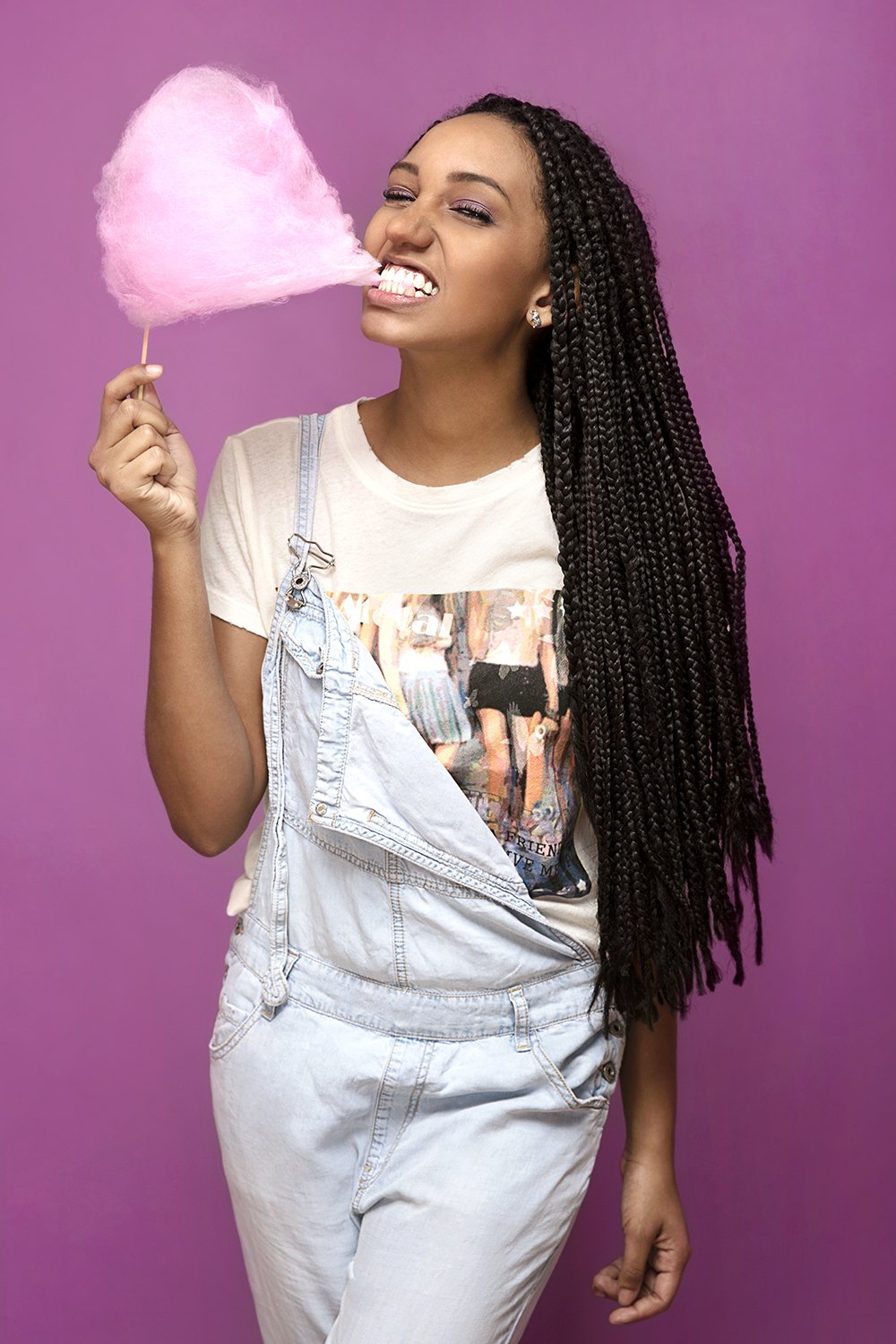 Biting into a cloud of pink candy floss against the magenta wall