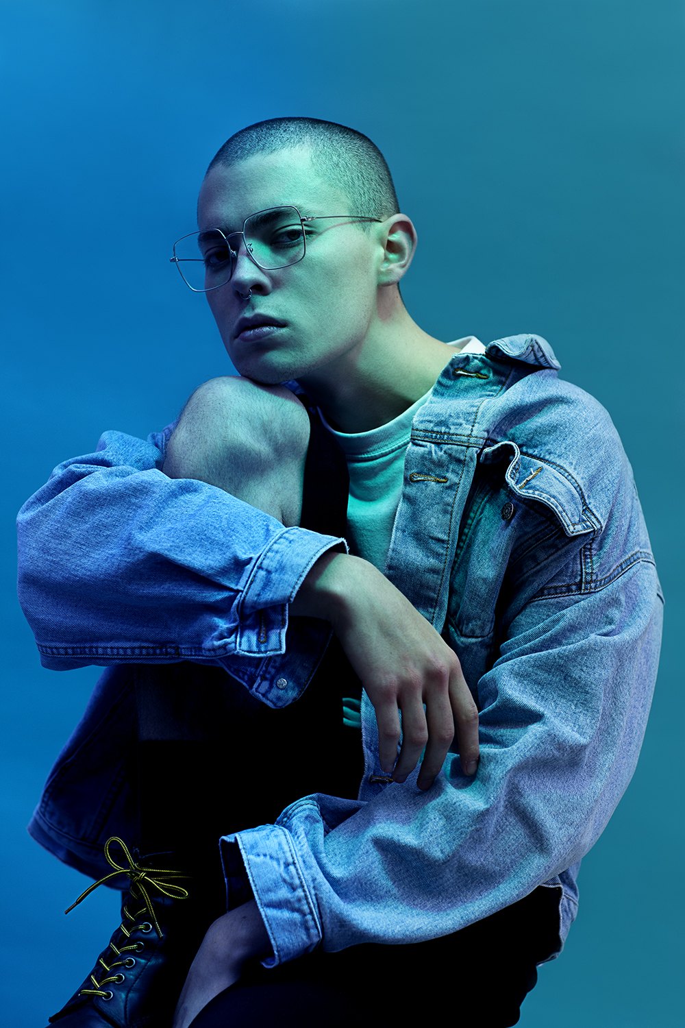 Leaning forward in double denim, green and blue gels crossing the face