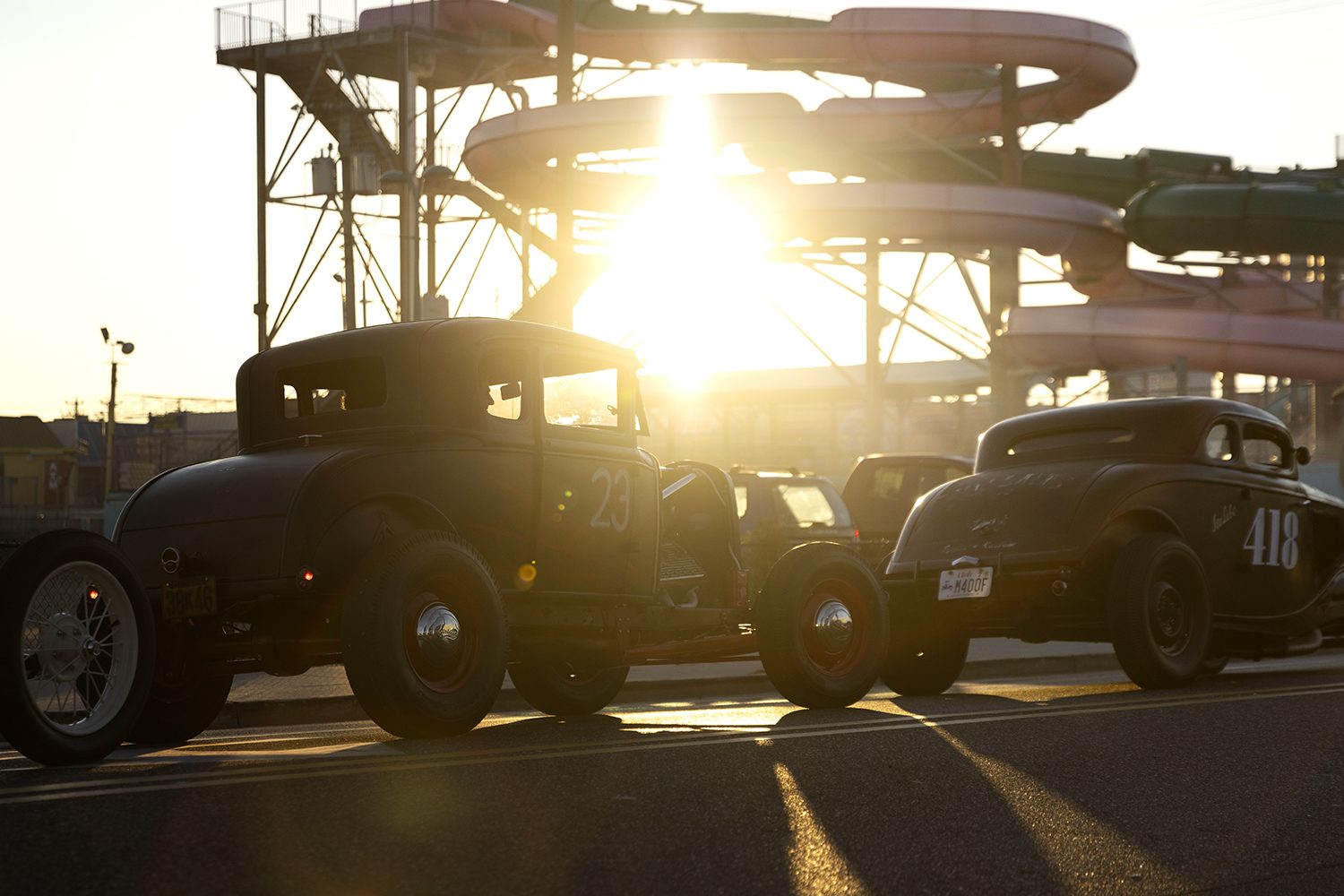 Hot rods silhouetted against a low sun