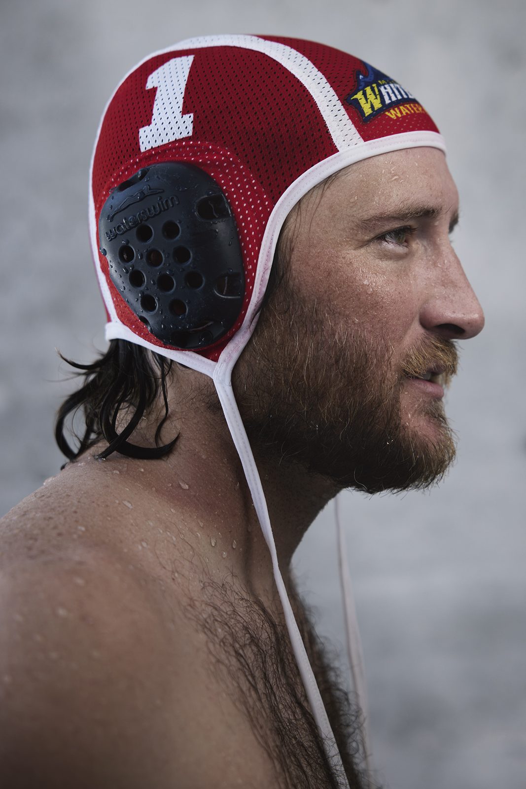 A bearded player in a number-one cap, mid-game